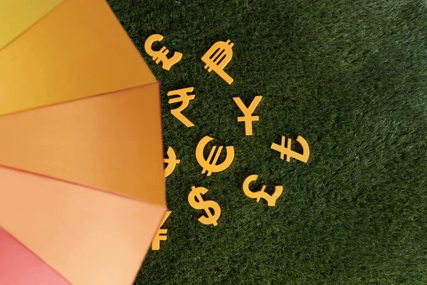 Colourful umbrella and money — Stock Photo, Image