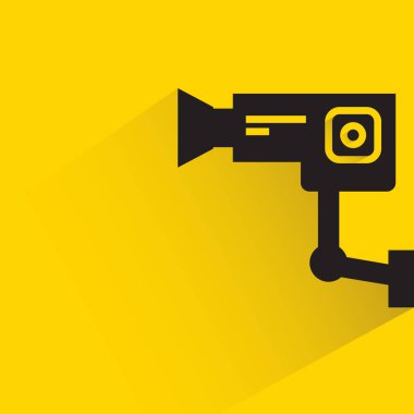 Sarı arka planda gölgesi olan CCTV