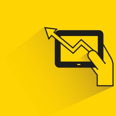 tablet ve borsa grafiği sarı zemin üzerinde gölge