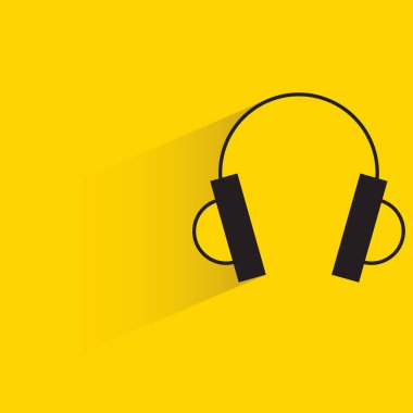 Sarı arka planda gölgesi olan kulaklık