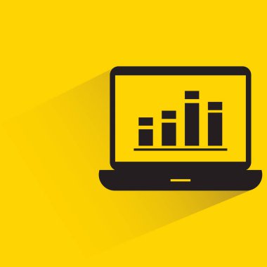 laptop computer and data chart with shadow on yellow background