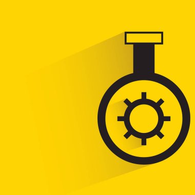 flask and gear with shadow on yellow background