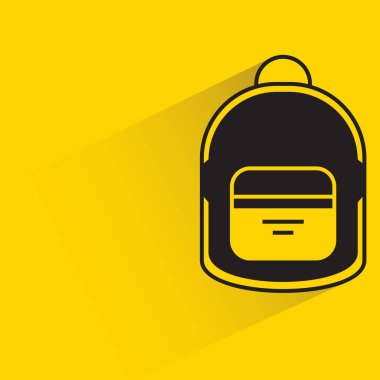 school bag with shadow on yellow background