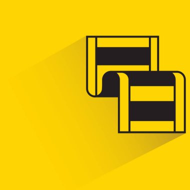 film with shadow on yellow background