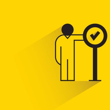 man with checkmark signage icon on yellow background