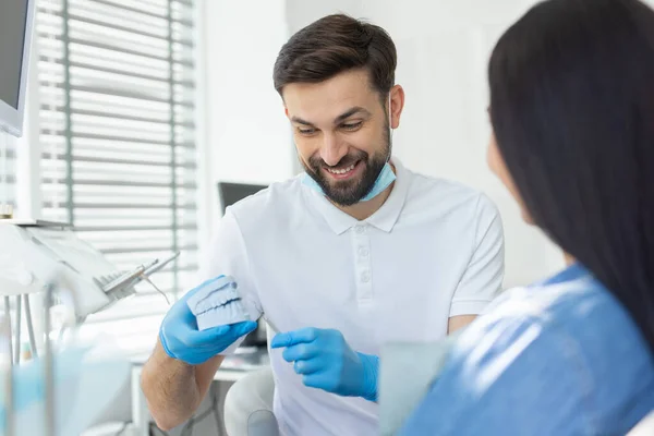 Male Smiling Dentist Showing Jaws Model Woman Hospital — Stock Photo, Image