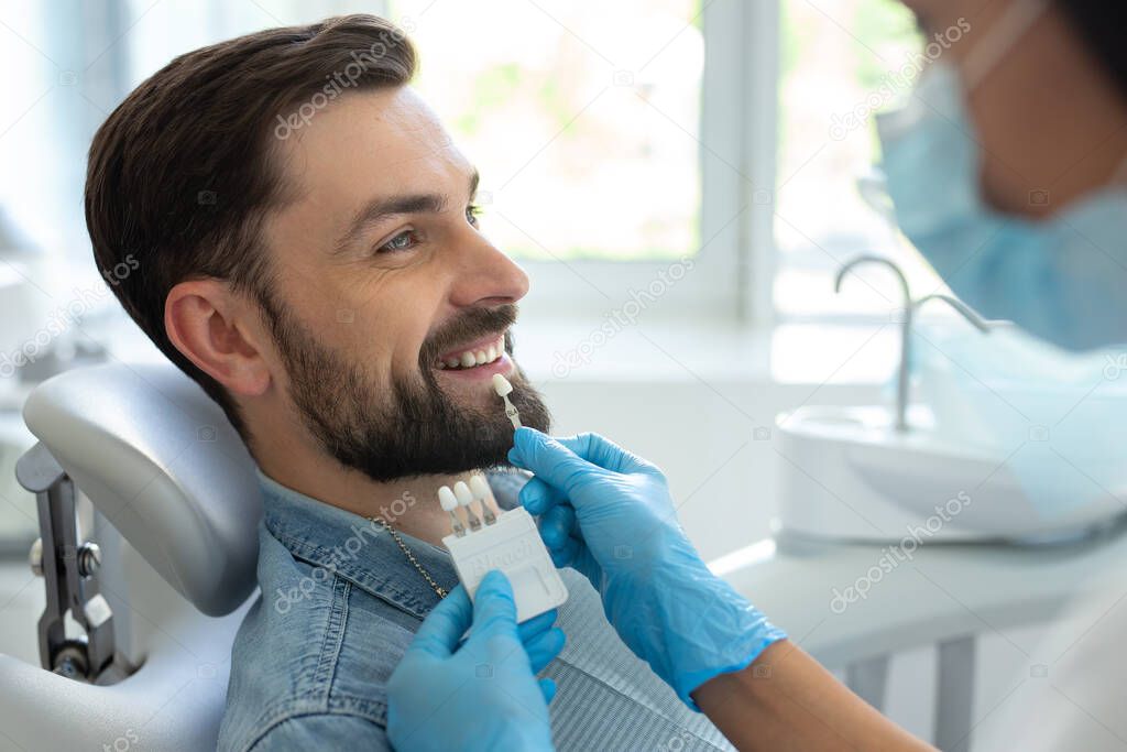 side view of patient choosing tooth implants with doctor in hospital
