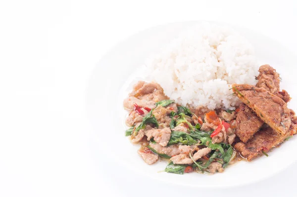 Тайская кухня, закрыть Райс увенчанный перемешать жареную свинину и базилик — стоковое фото