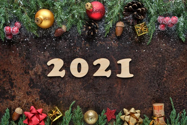 New Years Eve festive background with wooden numbers 2021 and Christmas decorations on stone surface. Flat lay, view from above