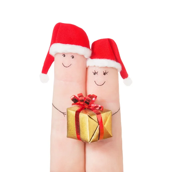 Dedos rostos em chapéus de Santa com caixa de presente — Fotografia de Stock