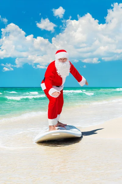 Santa Claus windsurfer go surfing with surfboard at ocean waves — Stock Photo, Image