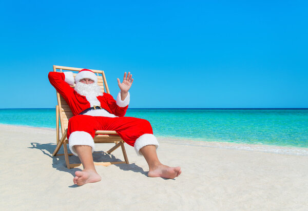 Christmas Santa Claus relaxing on deckchair at ocean tropical be