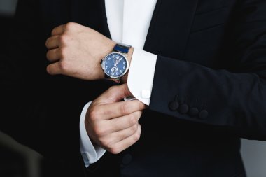 the groom puts on a watch clipart