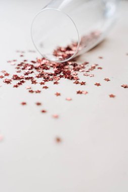 red little decor stars in champagne glass, new year 2021 mood background, copy space