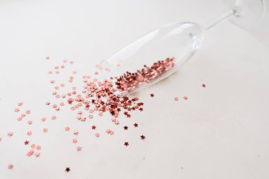 red little decor stars in champagne glass, new year 2021 mood background, copy space