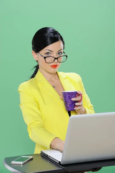 Businesswoman phoning and working with laptop isolated on chroma green background — Stock Photo, Image