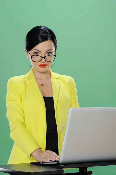 Businesswoman phoning and working with laptop isolated on chroma green background — Stock Photo, Image