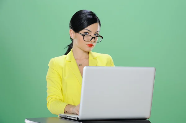 Businesswoman phoning and working with laptop isolated on chroma green background Stock Picture