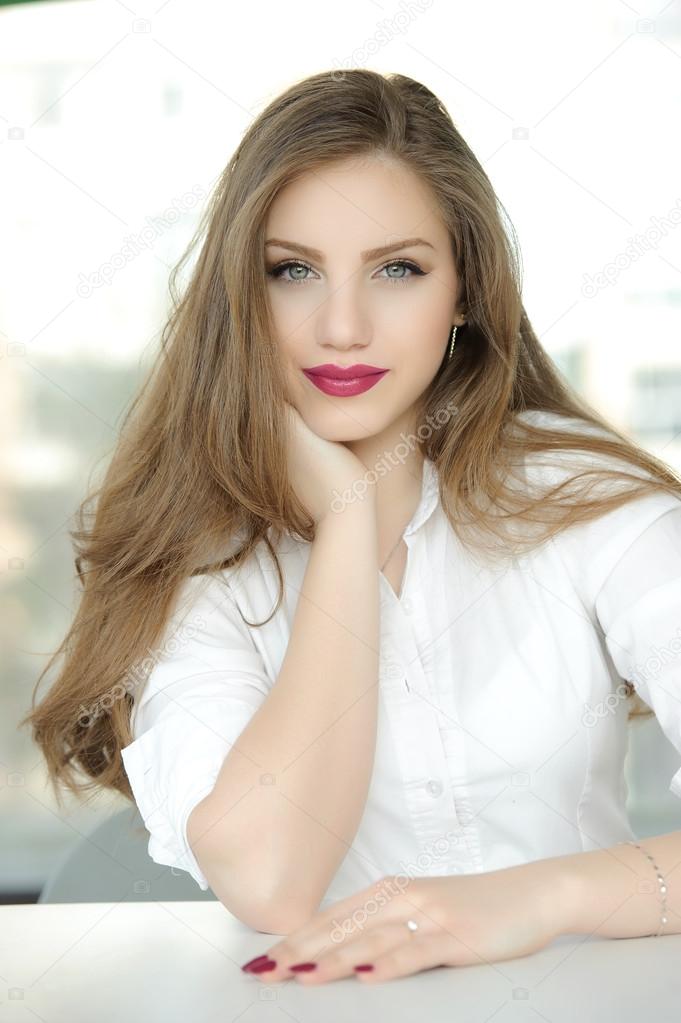 Portrait of elegant middle aged ( mature ) woman smiling in living room