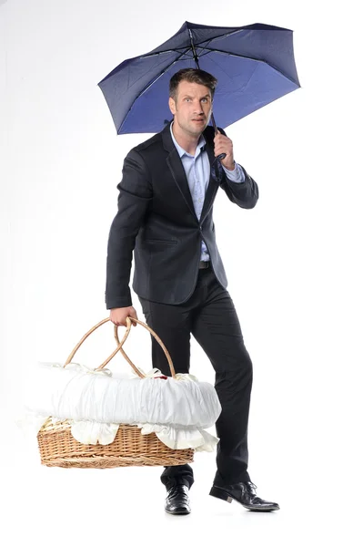 Business man carrying a basket with newborn baby — Stock Photo, Image