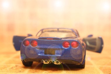 sporty blue toy car on a blurred background. Travel concept