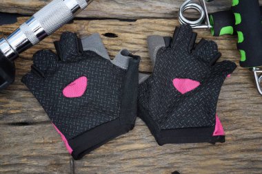 Sports equipmen dumbbell and glove fitness concepts  on wood table background