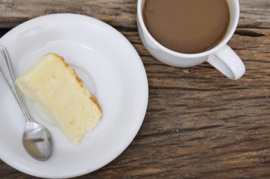 Butter cake homemade and coffee cup on wood table