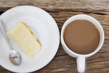 Butter cake homemade and coffee cup on wood table