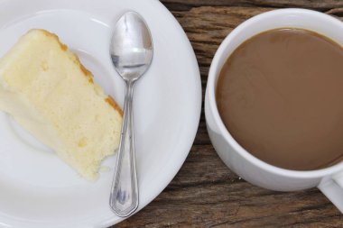 Butter cake homemade and coffee cup on wood table