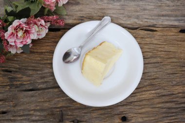 Butter cake homemade and tea spoon on wood table