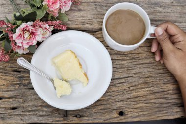 Butter cake homemade drinking coffee cup and hand on wood table