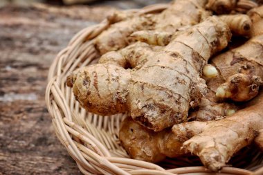 Kahverengi ahşap masa zemininde zencefil kökü tropikal bitki