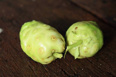 Close up of noni tropical fruit on wood background