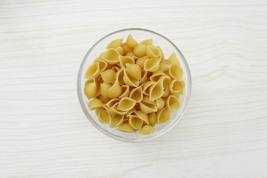Italian raw pasta conchiglie rigate macaroni shells Traditional food.