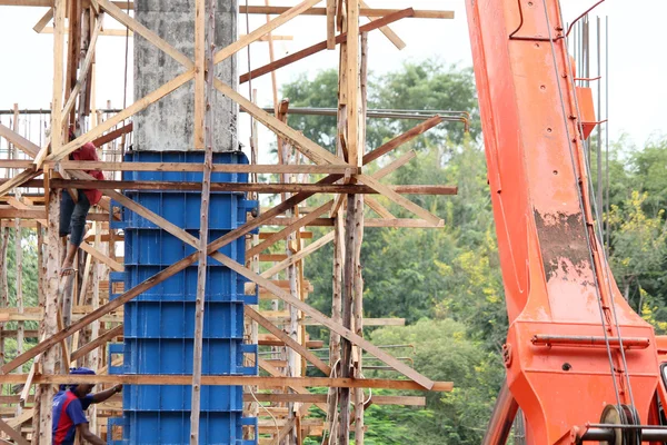 Crane and unfinished building at construction site — Stock Photo, Image