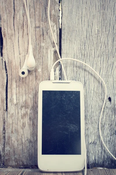 Chytrý telefon s sluchátka — Stock fotografie