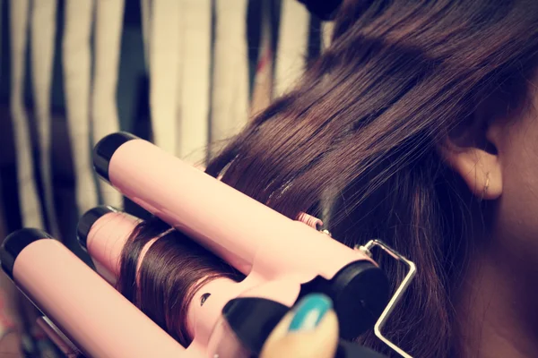 Mulher usando alisador de cabelo — Fotografia de Stock