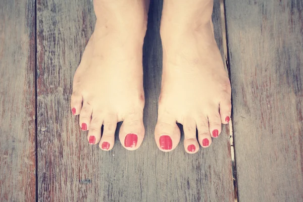 Woman feet with red nail polish — Stock Photo, Image