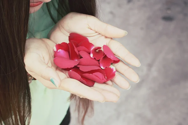 Kobieta z płatków róży — Zdjęcie stockowe