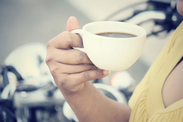 Woman drinking coffee with motorcycle — Stock Photo, Image