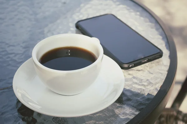 Гаряча кава зі смартфоном — стокове фото