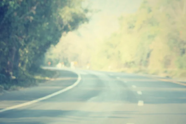 Bosque borroso con carretera —  Fotos de Stock