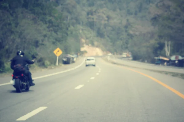 Blurred of driver riding motorcycle on the road — Stock Photo, Image