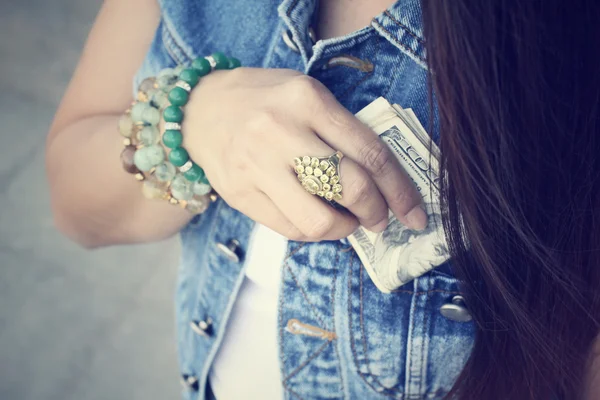 Woman with dollar in jeans jacket — Stock Photo, Image