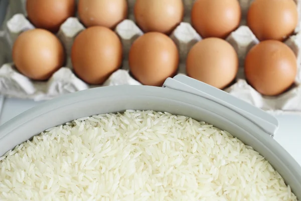 Raw rice grain with eggs — Stock Photo, Image