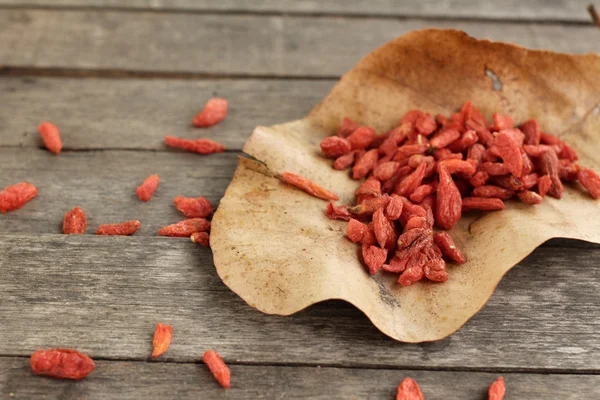 Dried goji berries on wood background — Stock Photo, Image