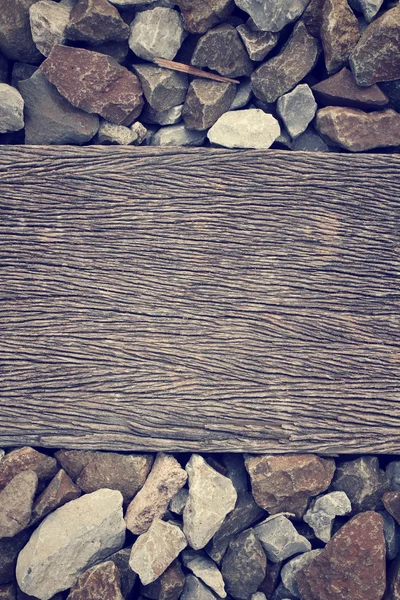 Piedra con fondo de madera — Foto de Stock