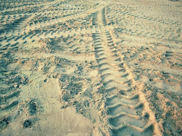 Wheel tracks on the soil.