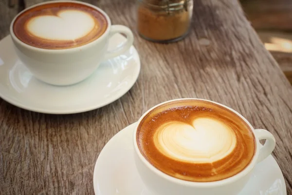 Two cups of latte art coffee Royalty Free Stock Images