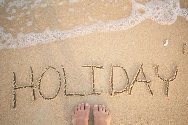 Selfie of word holiday written in sand on beach — Stock Photo, Image